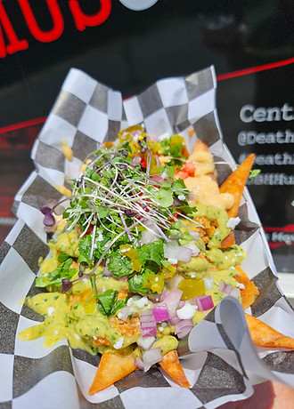 BBQ Chicken Pita Nachos. Pita Nachos Topped With Grilled BBQ Chicken, Melted 3 Cheese Blend, Diced Tomato, Red Onion, Hummus