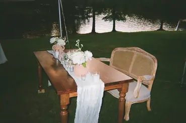 Minimal wooden sweetheart table with soft neutral decor for Charlotte wedding.