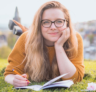 woman-lying-on-green-grass-while-holding