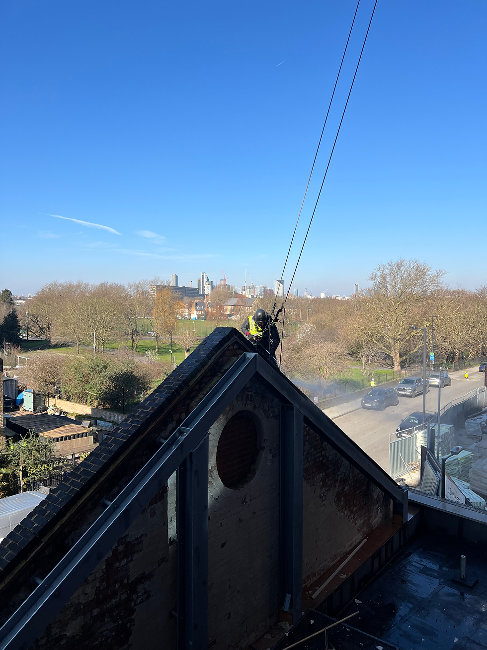 Rope Access Technician carrying out pressure washing on exterior building facade in London
