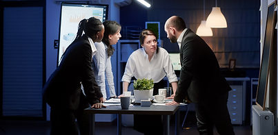 diverse-multi-ethnic-teamwork-standing-around-conference-table-brainstorming-ideas.jpg