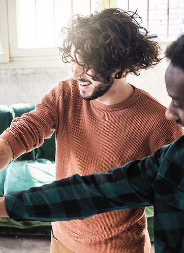 happy-multi-ethnic-friends-portrait-standing-campus-room-while-making-fist-bump-as-symbol-