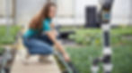 Woman checking garden irrigation system