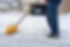 low-section-man-cleaning-snow-road_1048944-21471165.jpg