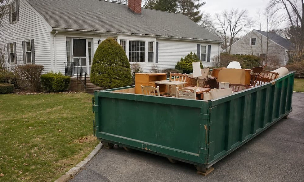 Dumpster filled with estate cleanout items.