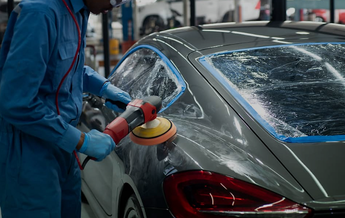 Car body shop technician sanding vehicle panel for repair and paintwork – Bar Auto Ltd