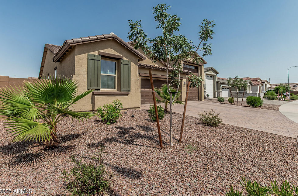 An Avondale Arizona home featuring a front yard landscaped with decorative gravel, young desert plants, and a clean, low-maintenance design that compliments the stucco home.