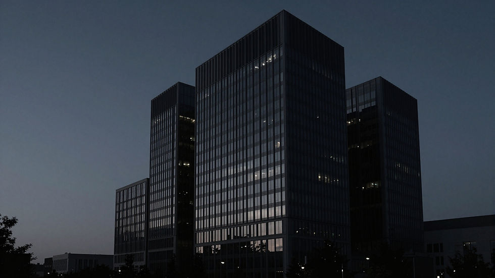Modern office buildings at dusk with lit windows