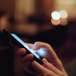 A person sends a message on a mobile phone