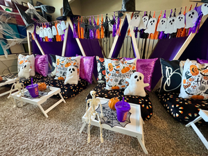 Halloween-themed sleepover tent setup with cozy fall decorations