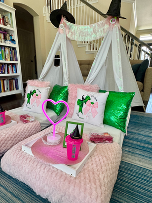 Wicked-inspired sleepover tent with pink bedding and green accents