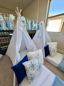 Silver winter decorations displayed beside a cozy sleepover tent