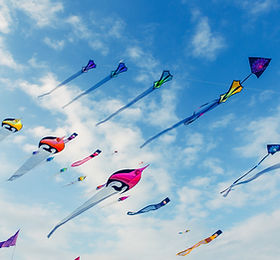 Kites Flying in Cloudy Sky