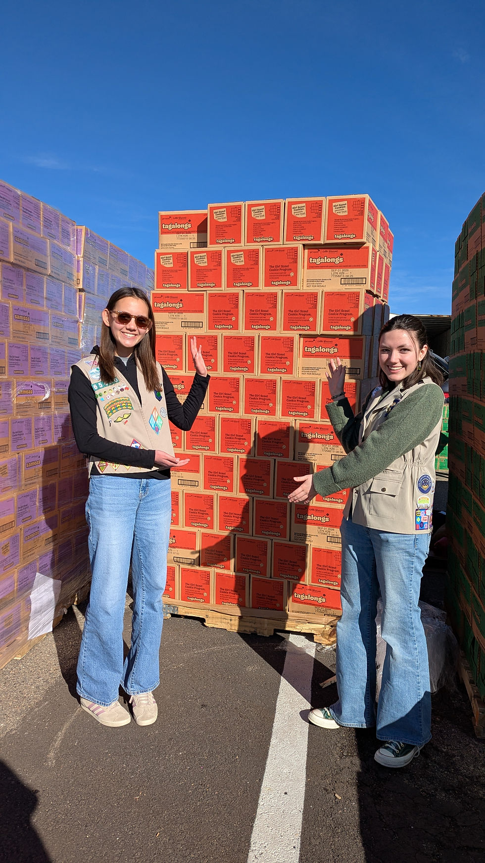 Bianca (right) shows off a pallet of Tagalongs during 2026 Cookie Delivery Day.