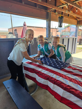 Members of troop 45213 pose with flags they are retiring