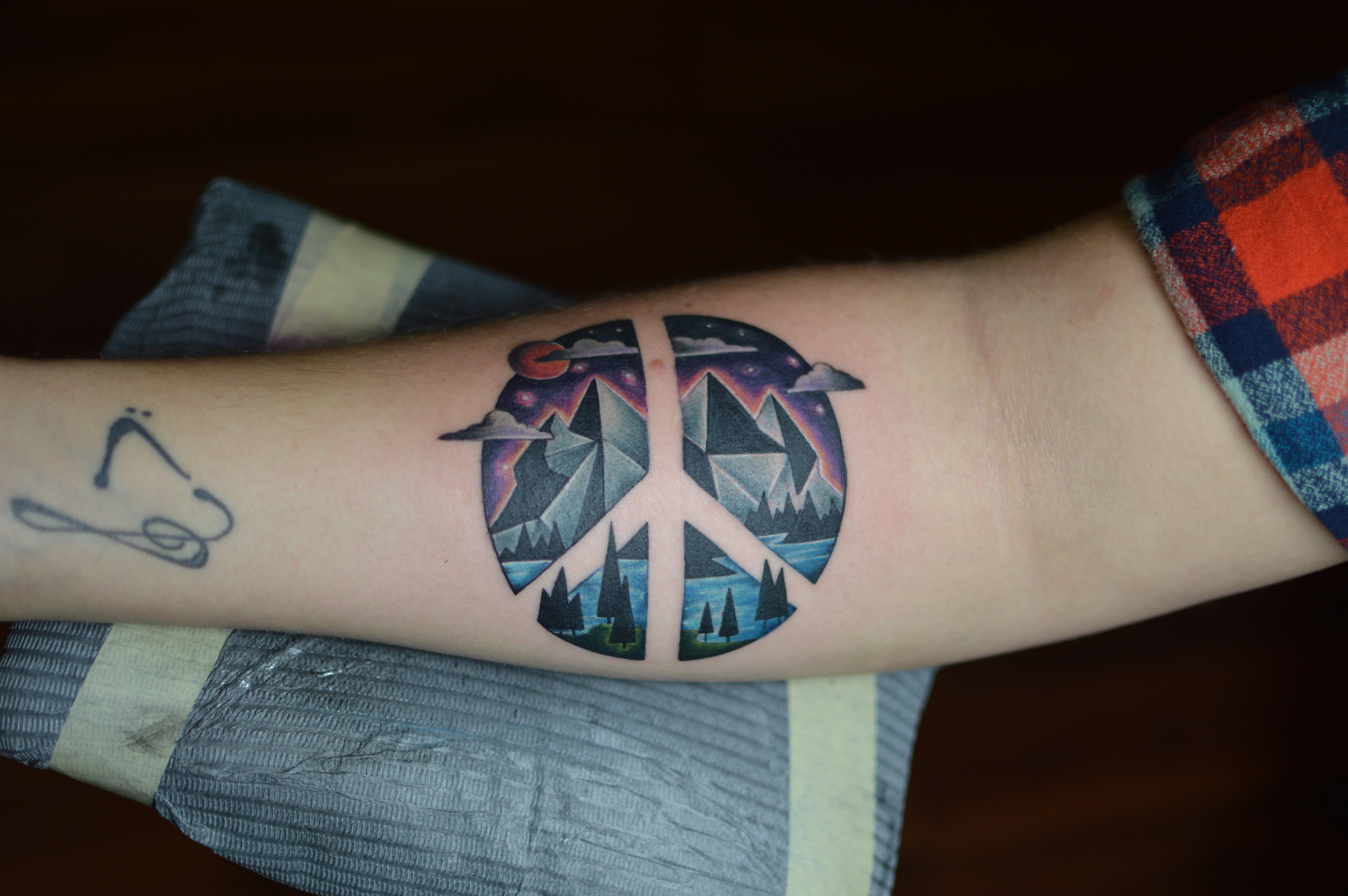 Peace sign tattoo