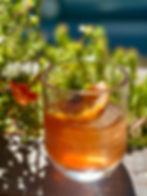 Shot of bourbon cocktail in stateside vodka glass outsde of third and ferry fish market in downtown easton pa