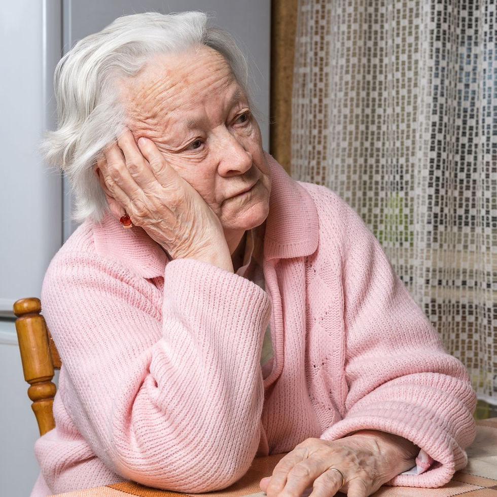 Lady sitting at a table with her head resting on one hand, looking fed up.