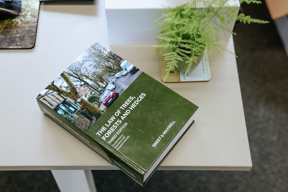 The book 'The laws of trees, forests and hedges' sits on an office desk