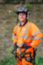 a smiling tree surgeon for South Bucks Tree Surgeons takes a break during a commercial project