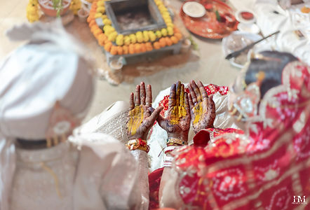 Bride and groom performing traditional wedding rituals during the ceremony