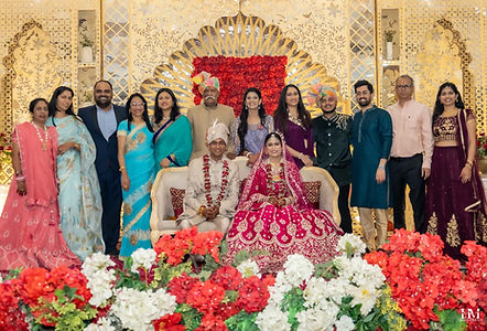 Wedding guests and family posing with the bride and groom in Jaipur