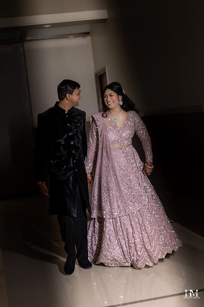 Bride and groom walking together in their sangeet night outfits