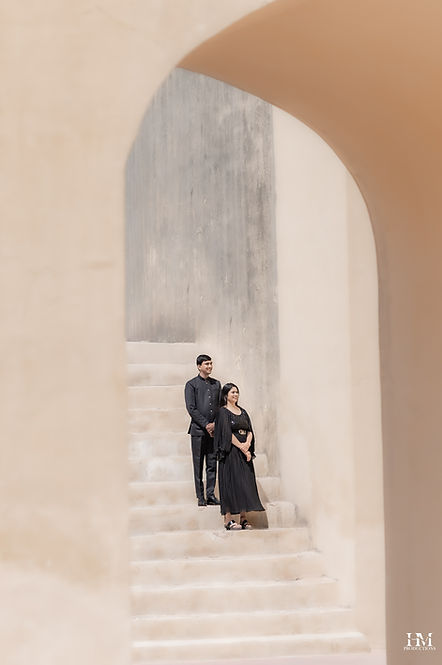 Couple posing on architectural stairs during a pre-wedding photoshoot - Jantar Mantar, Jaipur