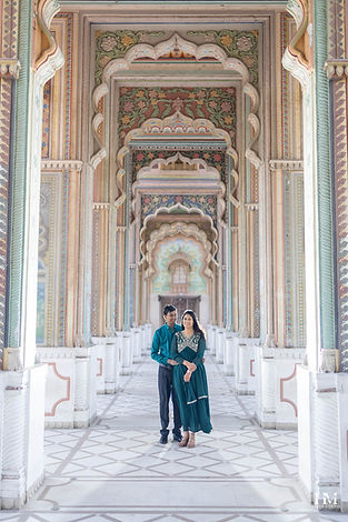 Couple portrait framed by colourful carved doorways during a pre-wedding shoot - Patrika Gate