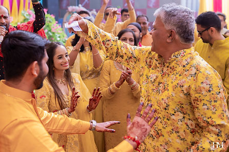 Family celebrating during a traditional Haldi ceremony