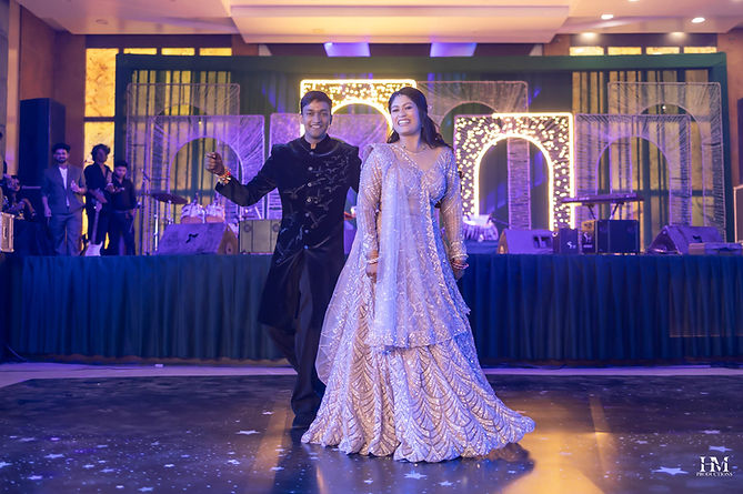 Bride and groom dancing together on an illuminated wedding stage