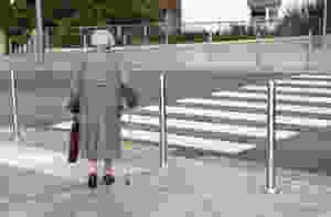 Elderly woman crossing the street