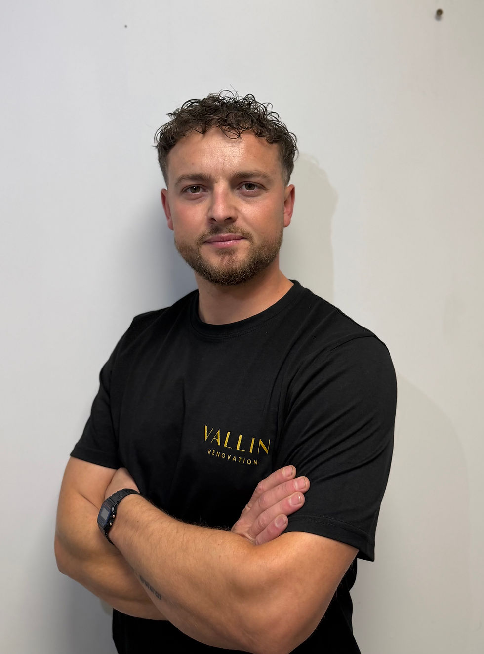 Homme aux bras croisés portant un t-shirt VALLIN Rénovation qui se nomme Jérôme VALLIN.