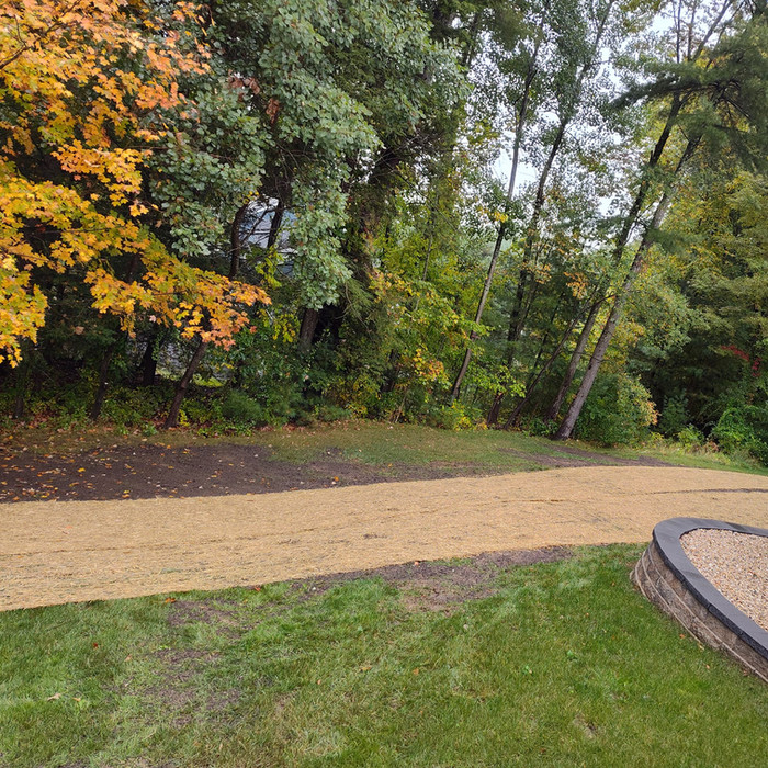 Customer's newly seeded lawn with erosion control straw mat
