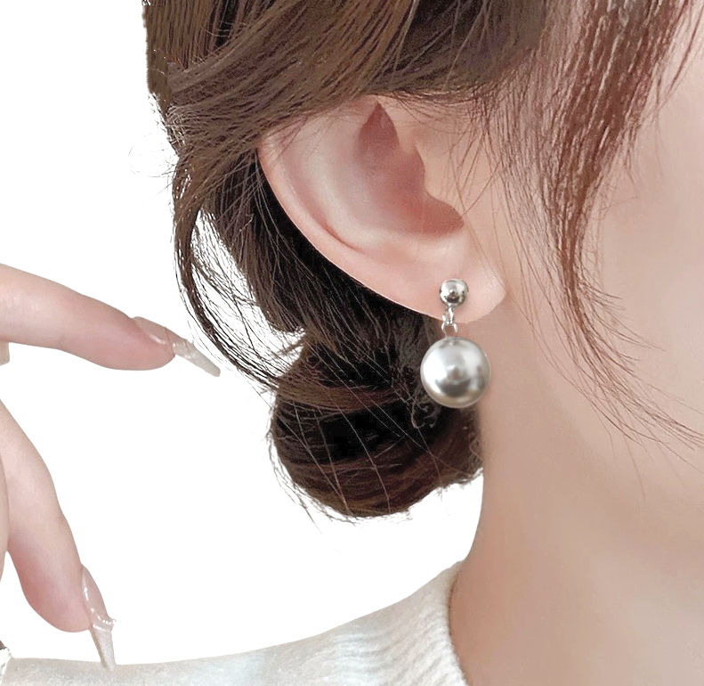 Elegant gray pearl earrings on a display card, featuring a modern design with a silver stud and a large gray pear