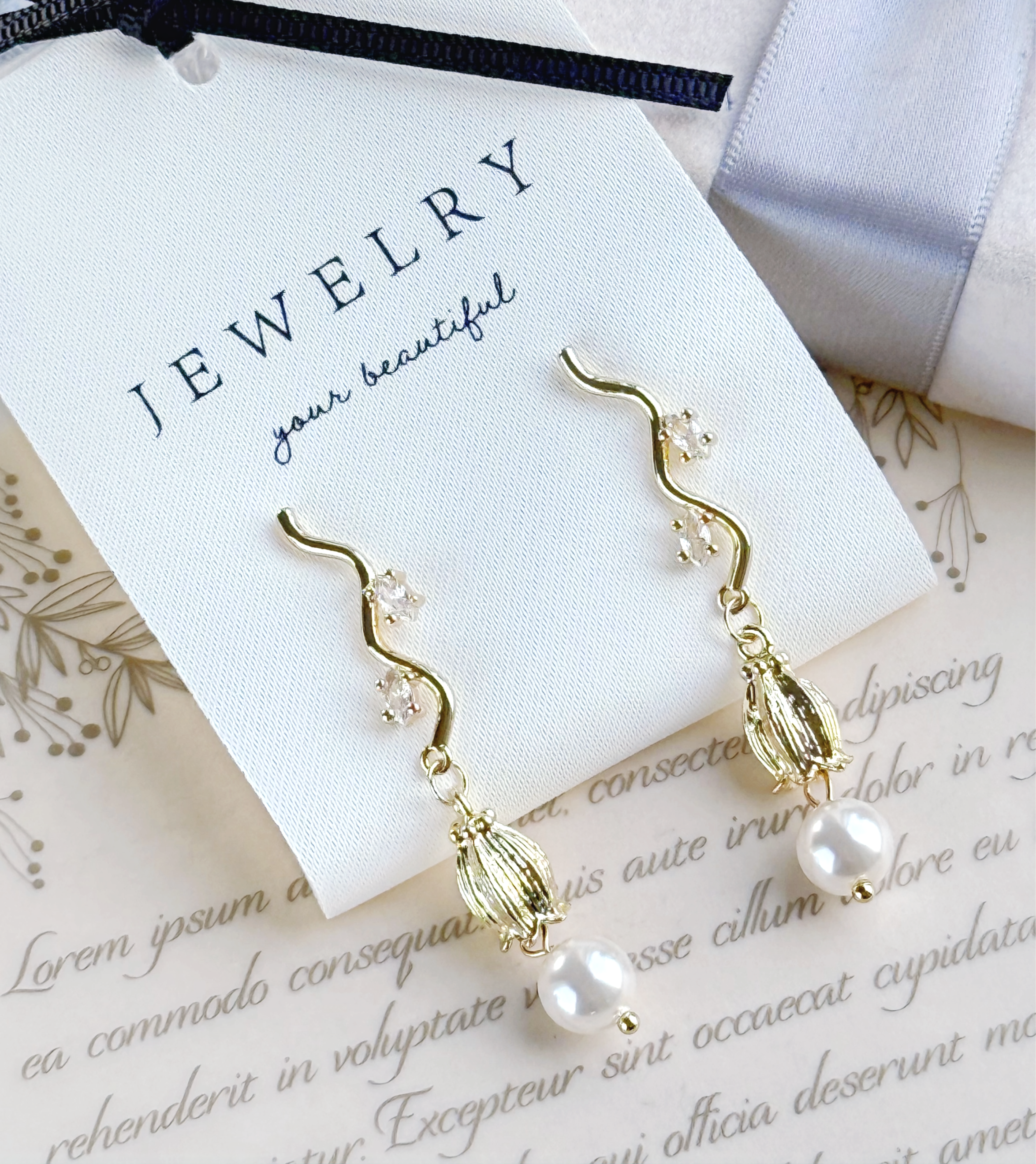 featuring a unique curved design with sparkling crystals and round pearls