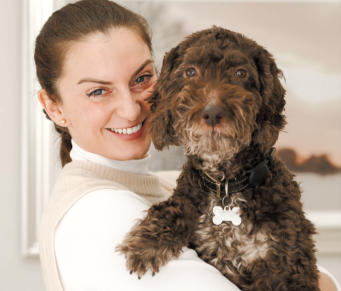Dr Sara holding a Cockerpoo during a home veterinary visit in Bath