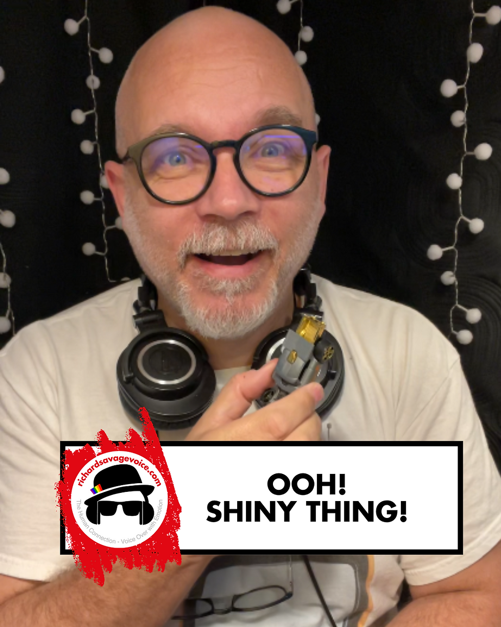 A man with headphones around his neck holds a Hot Wheels Aristo Rat toy car and looks into the camera with a look of wonder on his face. A graphic shows the richardsavagevoice.com logo and web address along with the words "Ooh! Shiny thing!".