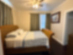 Full size bed with pale blue and white bedding