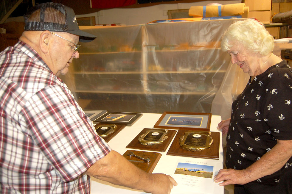 Howard and Joyce look over some of the awards they’ve won for their rebuilt vintage planes.
Photo by Scott Thoma
