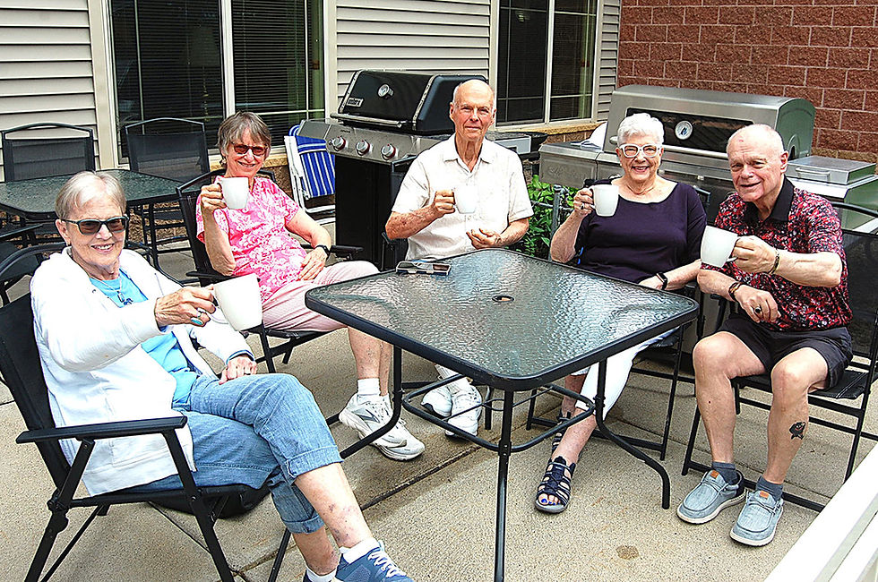 These residents at Realife Cooperative at Mueller Gardens enjoy a cup of coffee together on the patio. Left to right: Sharon Lorton, Jan Gembol, Larry Pfleger, Ruth Mestnik, and Bob Lacroix. Photo by Scott Thoma