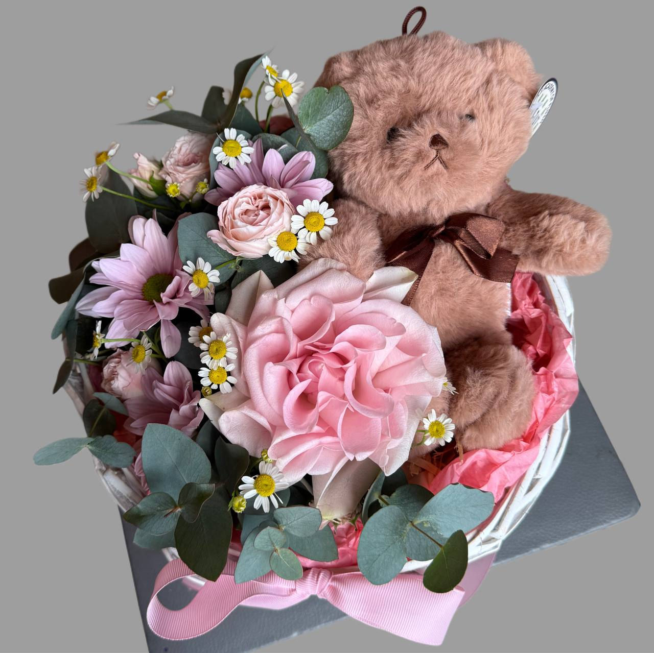 Flowers in a box with a teddy bear and a French rose