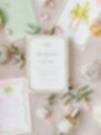 bright colored pink and green wedding invitation with watercolor details