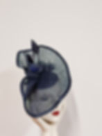 French Navy sinamay swirl headpiece with handmade flowers and arrowhead feather trim