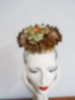 Brown and cream sinamay fascinator embellished with hydrangea blossoms.