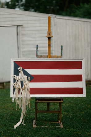 In lieu of my late Abuelo’s Puerto Rican heritage, and my Abuela’s recent decline in health, I’m introducing ‘Tata.’ Finally and formally, I have the opportunity to illustrate my grandfather's life from his arrival in NY, NY - his matrimony with my beloved, Abuela.

Some of these themes are looked at in celebrations and pride however, can be met with sadness, mourning and the consequences of unresolved trauma. 

This piece I’ve specifically titled ‘Tata’ as it relates to the Island of Puerto Rico and its unwavering efforts of independence, strife and celebration. 

The raw canvas, shredded to reveal a pearl rosary is a pendulum of my own experiences and emotions growing up Roman Catholic while also feeling the internalized guilt of being a member of the LGBTQ community in my youth. 

Thankfully, I have both my faith and pride as demonstrated in this piece. 

