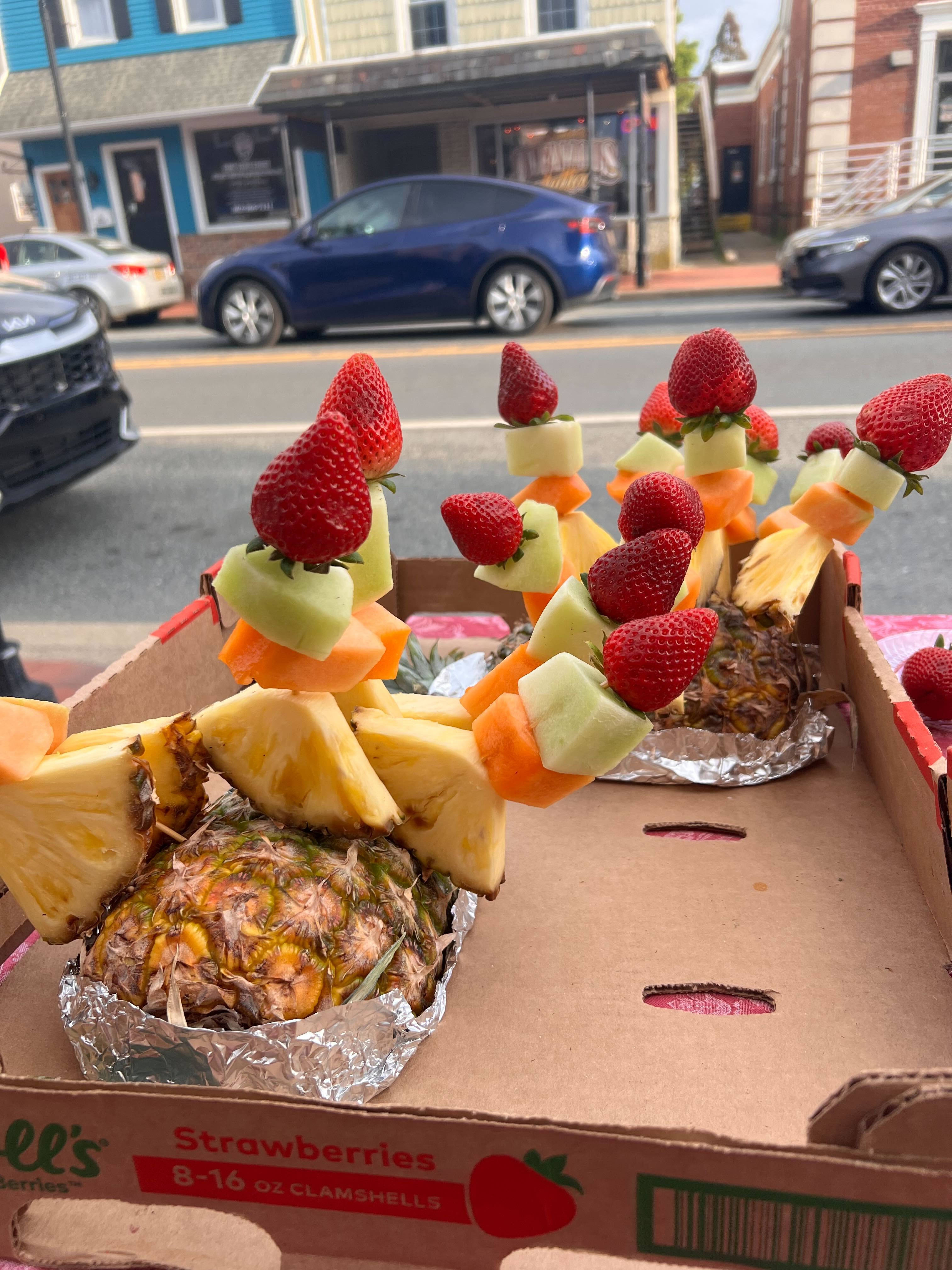 Fruit skewers displayed on hollowed pineapples during the Charcuterie Crawl