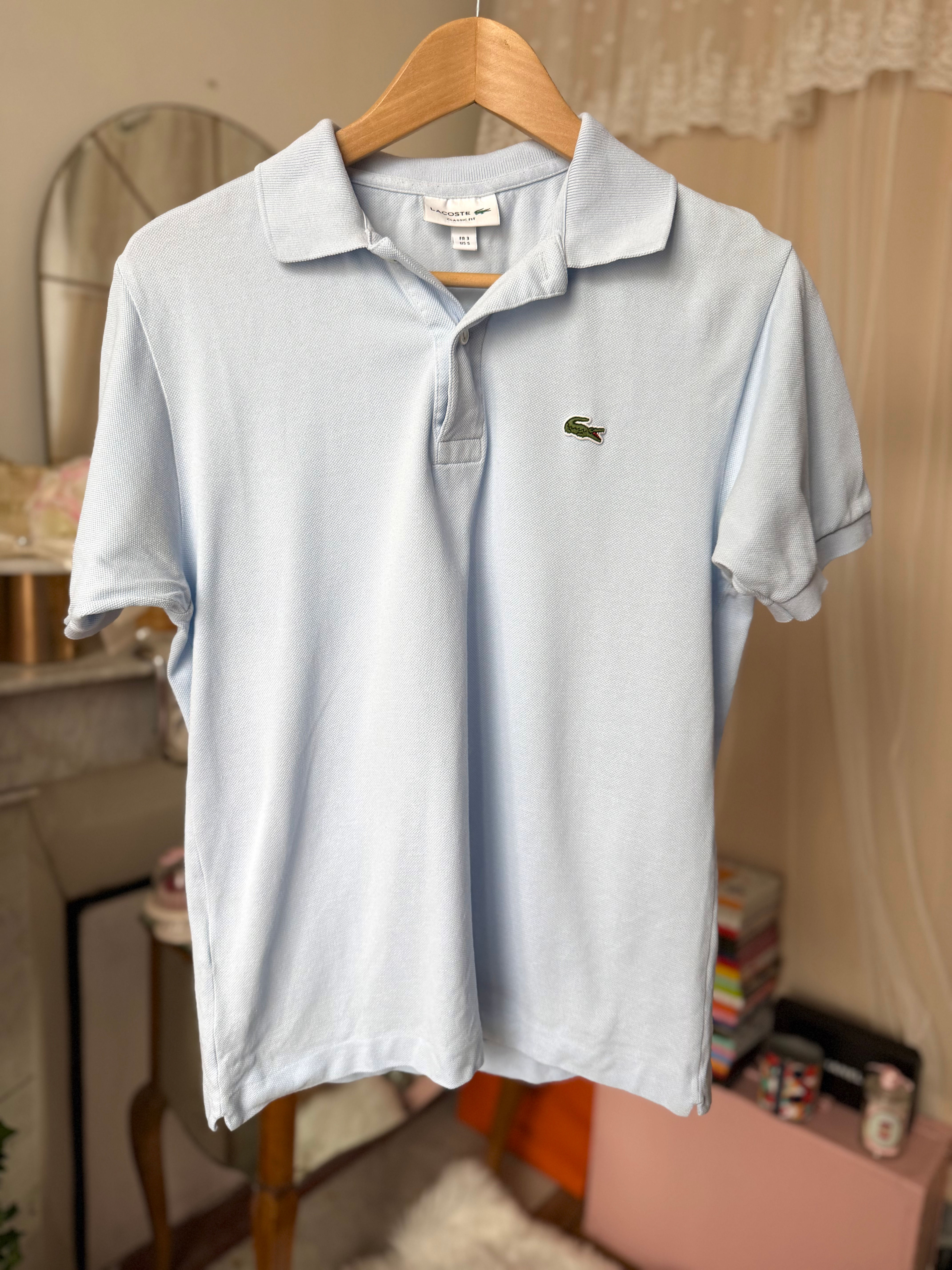 Polo Lacoste bleu clair taille m en bon état
