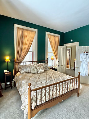 King bed in Monet Suite with dark green walls at Hamilton House wedding venue