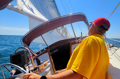 man in yellow shirt sailing